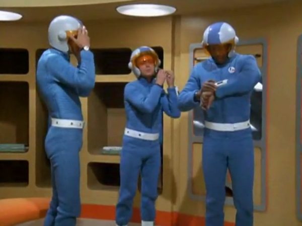 Moonbase - The scene when interceptor pilots slide down the tubes to reach their cockpits – is one of the most famous and beloved moments in retro sci-fi history. Battlestar Galactica (both the original 1978 version and the famous 2004 reboot) "borrowed" that exact concept!
The Low-Tech "Tube" Illusion - The sequence you are smiling about is a perfect example of how the British crew used pure physical tricks instead of expensive technology to make something look highly cool. Sometimes they succeeded, somethimes failed.
The Look - When the alien alarm rings, the three pilots jump out of their blue zipper-pyjama uniforms and slide feet-first down these bright metal chutes. The camera cuts, and suddenly they are sitting perfectly upright in their spaceship seats, ready to launch.
The Reality - There were no complex mechanics. The actors literally just sat on playground-style metal slides in the studio. They slid down into a mattress on the floor out of frame. Then, the camera would cut to a completely different set where they were already strapped into the cockpits. It was cheap, simple, and looked incredibly futuristic for 1970.
It Shaped Modern Sci-Fi
When Battlestar Galactica came out later, the American creators copied this exact pacing. They took that thrilling, fast-paced sequence of pilots scrambling from their quarters, jumping into launch tubes, and shooting out into space in their Viper fighters. By combining the glamorous, stylish lifestyle of the base with the gritty, mechanical reality of the pilots, UFO created the blueprint for how modern sci-fi handles military organizations in space.
It proved that you can have a show that is deeply focused on high-tech military strategy, while still ensuring the background is filled with enough visual style and glamour to keep the audience under that "hypnotic screen" spell.
The Contrast - Moonbase Beauties vs. The Boys' Club
The way the show balanced sex appeal with this "advanced space team" is where the corporate logic gets really funny. On one side of the Moonbase, you have the female officers wearing heavy makeup, purple hair, and tight silver miniskirts. They are the ones tracking the alien radar and typing on the computers. But the moment a real fight starts, the show shifts to the three male pilots in their blue pajamas and matching silver motorcycle helmets.
It was a total reflection of 1970 society. The creators wanted the high-fashion, liberal visual hook of the "Moonbase Beauties" to get people to watch the screen, but when it came to the actual space battles, they reverted back to a traditional, serious military setup. The pilots didn't look sexy or futuristic – they looked like a highly trained bobsled team or racecar drivers.
