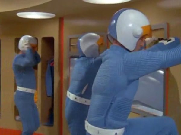 Moonbase - The scene when interceptor pilots slide down the tubes to reach their cockpits – is one of the most famous and beloved moments in retro sci-fi history. Battlestar Galactica (both the original 1978 version and the famous 2004 reboot) "borrowed" that exact concept!
The Low-Tech "Tube" Illusion - The sequence you are smiling about is a perfect example of how the British crew used pure physical tricks instead of expensive technology to make something look highly cool. Sometimes they succeeded, somethimes failed.
The Look - When the alien alarm rings, the three pilots jump out of their blue zipper-pyjama uniforms and slide feet-first down these bright metal chutes. The camera cuts, and suddenly they are sitting perfectly upright in their spaceship seats, ready to launch.
The Reality - There were no complex mechanics. The actors literally just sat on playground-style metal slides in the studio. They slid down into a mattress on the floor out of frame. Then, the camera would cut to a completely different set where they were already strapped into the cockpits. It was cheap, simple, and looked incredibly futuristic for 1970.
It Shaped Modern Sci-Fi
When Battlestar Galactica came out later, the American creators copied this exact pacing. They took that thrilling, fast-paced sequence of pilots scrambling from their quarters, jumping into launch tubes, and shooting out into space in their Viper fighters. By combining the glamorous, stylish lifestyle of the base with the gritty, mechanical reality of the pilots, UFO created the blueprint for how modern sci-fi handles military organizations in space.
It proved that you can have a show that is deeply focused on high-tech military strategy, while still ensuring the background is filled with enough visual style and glamour to keep the audience under that "hypnotic screen" spell.
The Contrast - Moonbase Beauties vs. The Boys' Club
The way the show balanced sex appeal with this "advanced space team" is where the corporate logic gets really funny. On one side of the Moonbase, you have the female officers wearing heavy makeup, purple hair, and tight silver miniskirts. They are the ones tracking the alien radar and typing on the computers. But the moment a real fight starts, the show shifts to the three male pilots in their blue pajamas and matching silver motorcycle helmets.
It was a total reflection of 1970 society. The creators wanted the high-fashion, liberal visual hook of the "Moonbase Beauties" to get people to watch the screen, but when it came to the actual space battles, they reverted back to a traditional, serious military setup. The pilots didn't look sexy or futuristic – they looked like a highly trained bobsled team or racecar drivers.